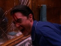 Dale Cooper smashes his head against a mirror and laughs