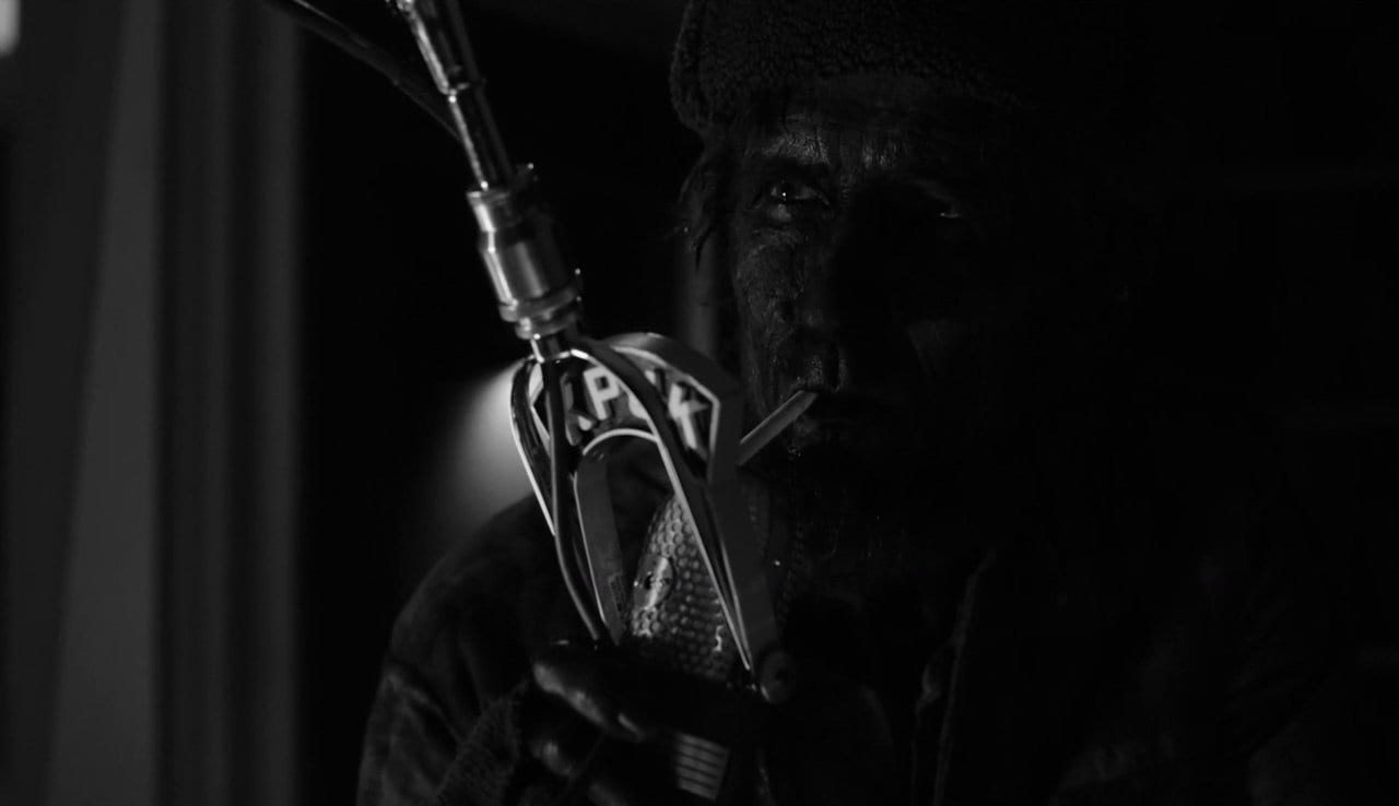 woodsman talking into a radio mic with cigarette in mouth