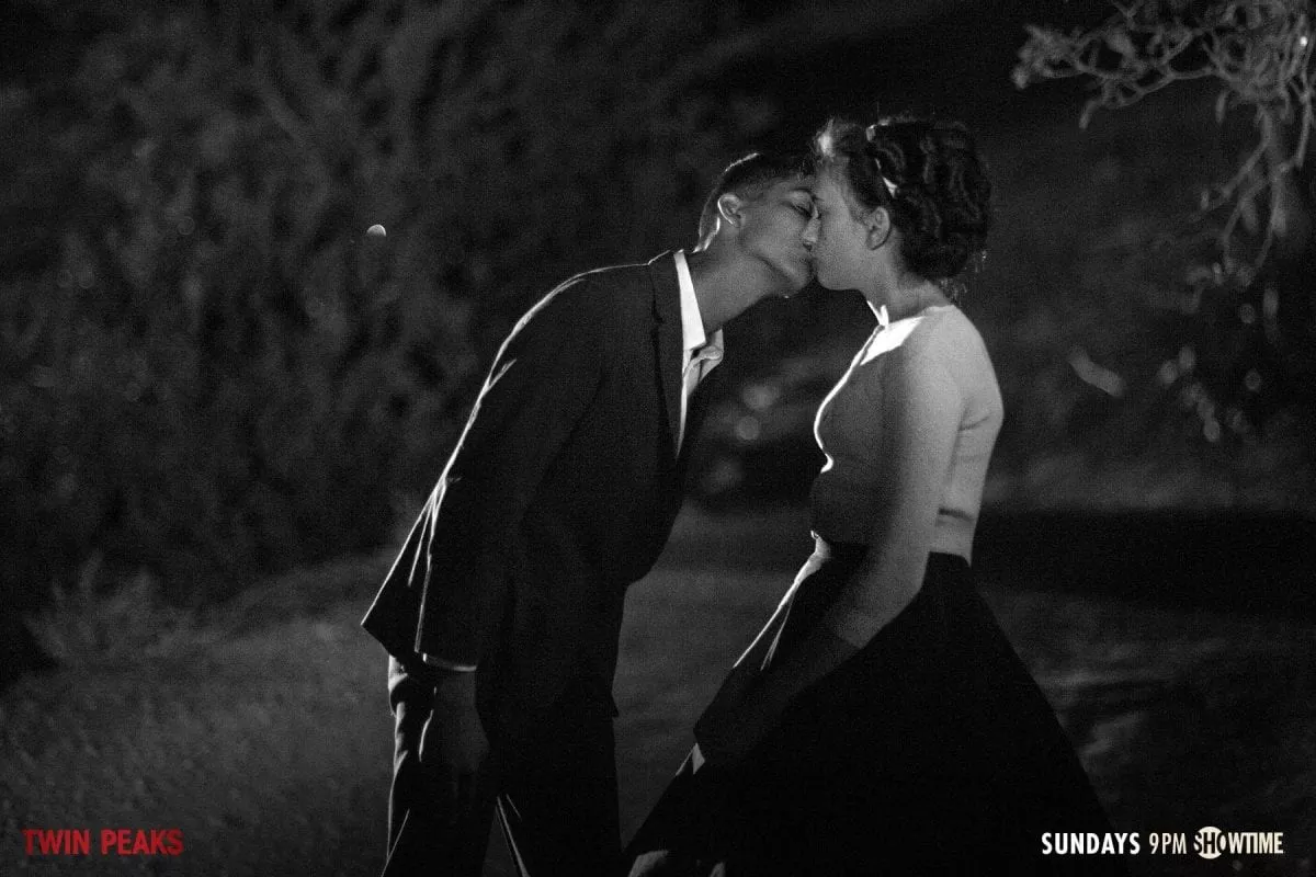 a boy kisses a girl at the end of their date