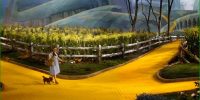 Dorothy and Toto walking down the yellow brick road, approaching a crossroads in the path.