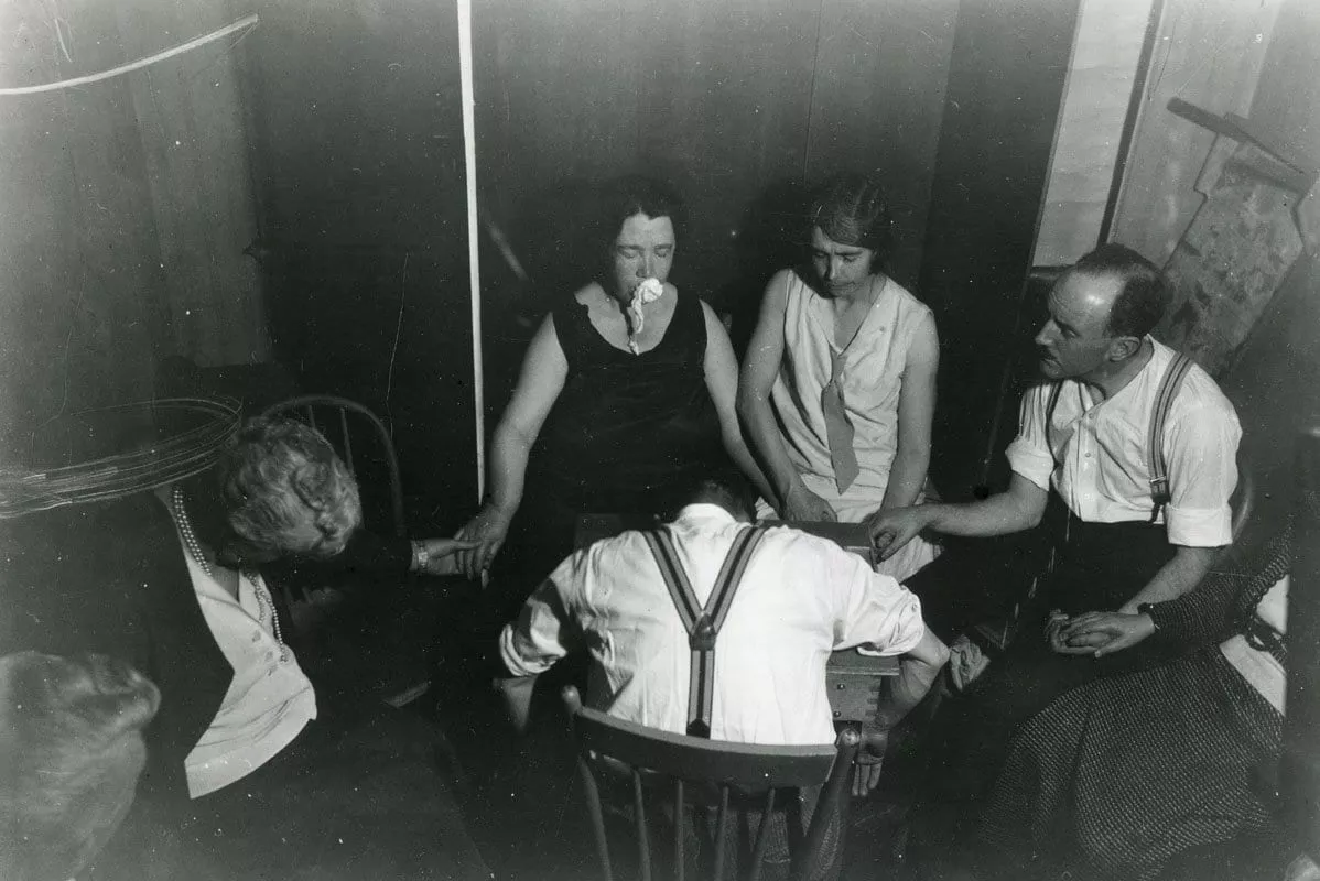 A seance in the 1920s-30s A seance where the medium allegedly exhibits ectoplasm