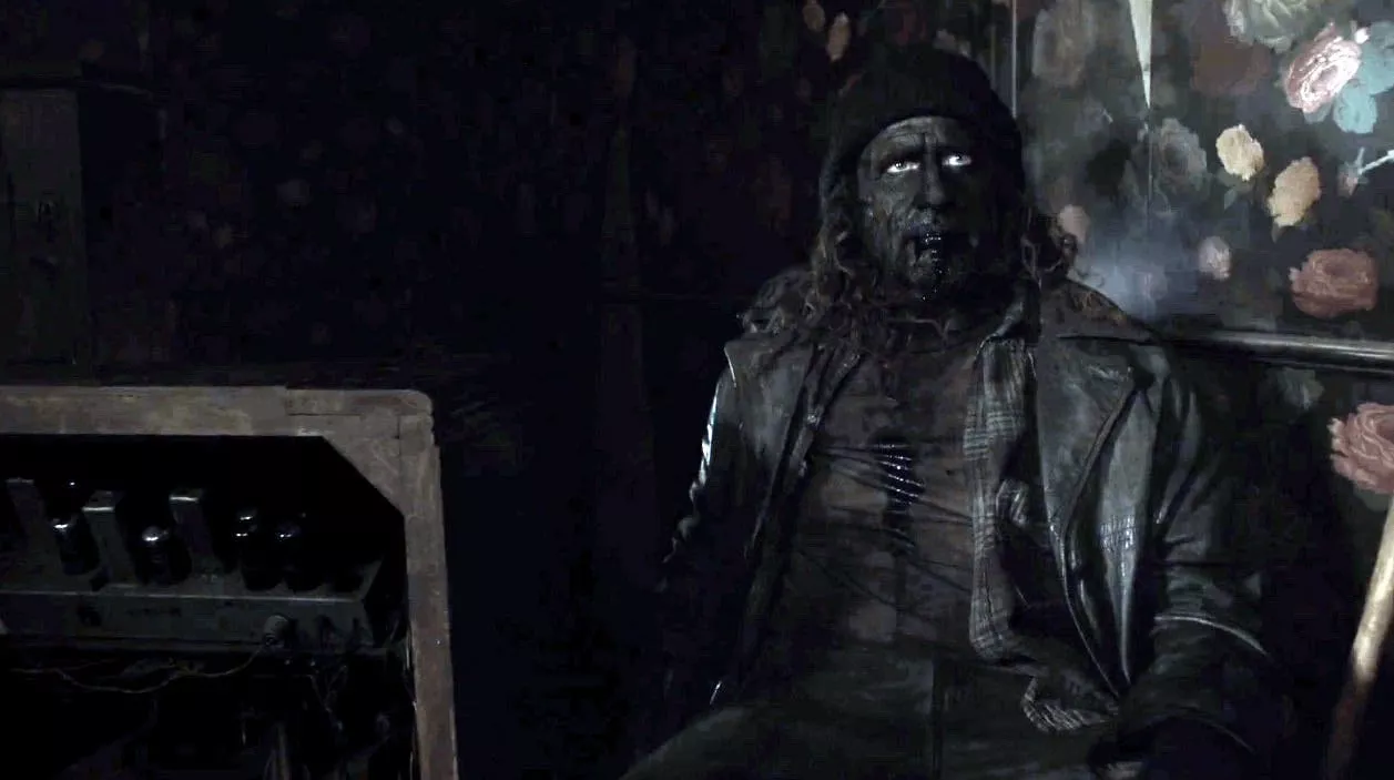 blackened woodsman woodsman next to a machine at the convenience store, black from head to toe