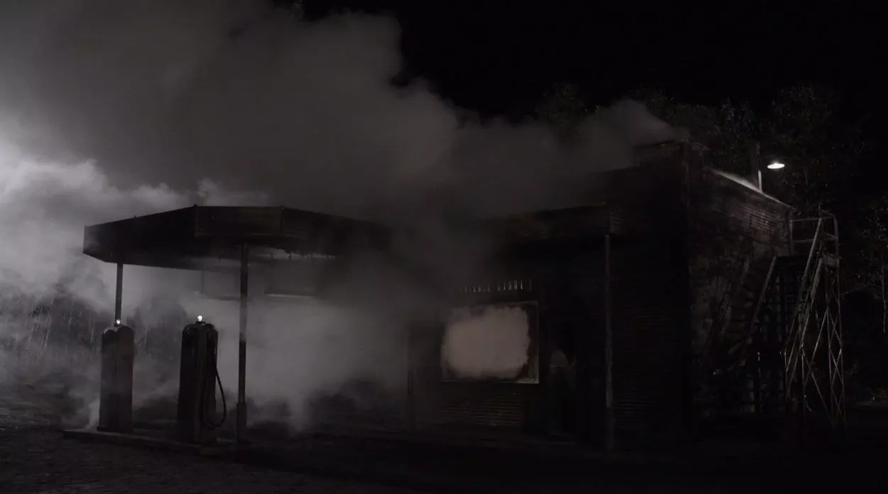 convenience store Smokes pours from the roof and windows of the convenience store