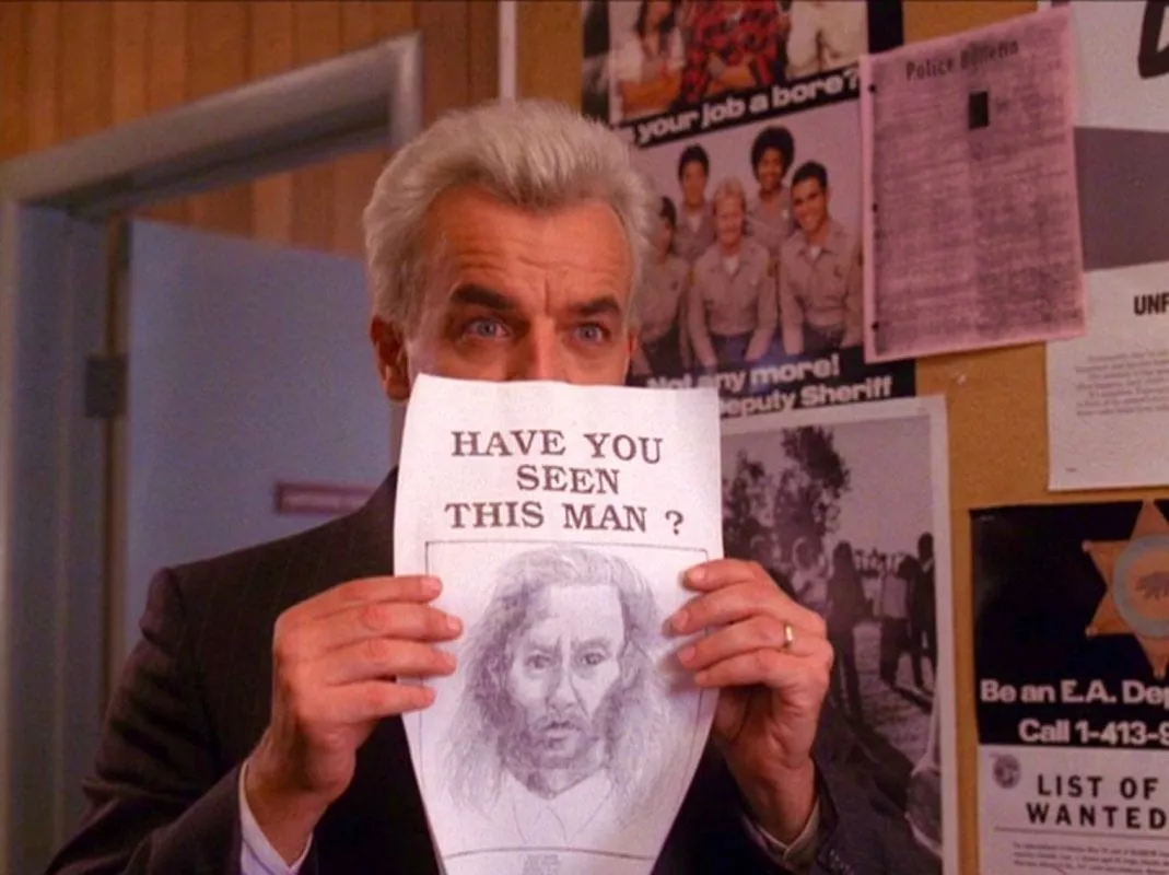 Leland holds up a picture of Bob