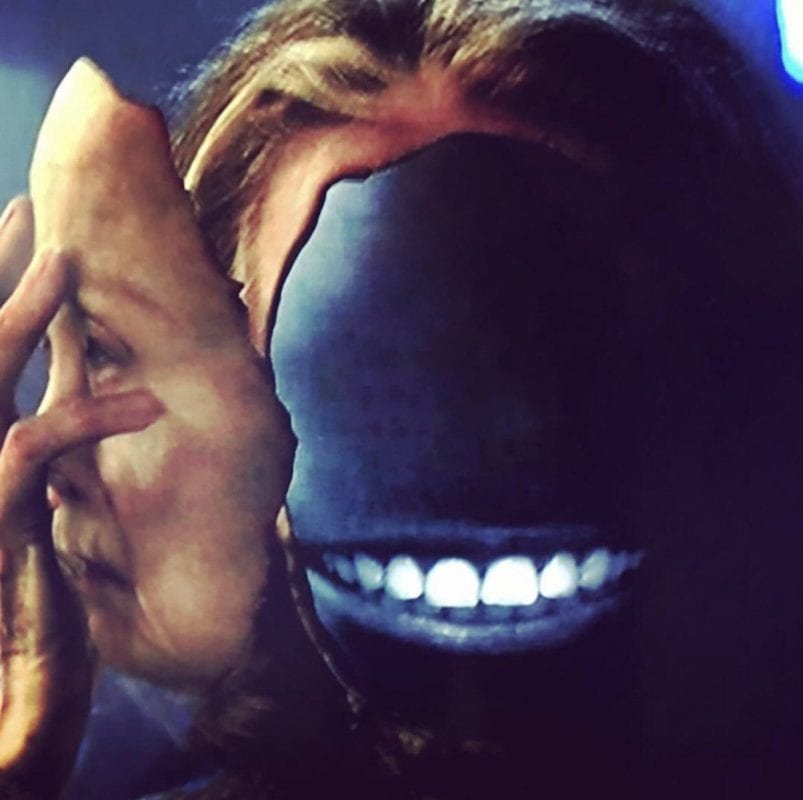 Sarah Palmer removes her face to reveal a big white grin