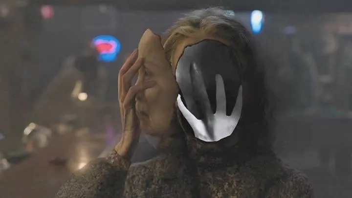 sarah palmer hand in face Sarah Palmers face removed with a hand with a black finger inside