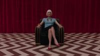Diane sits in a chair in the red room