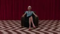 Diane sits in a chair in the red room