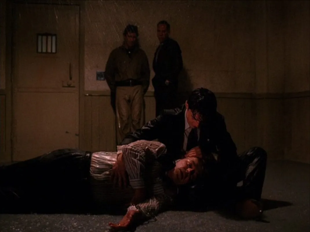 Cooper holds Leland as he dies from his head injuries at the sheriffs station