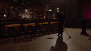 a man sweeping the floor of the bang bang bar