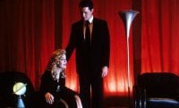 Dale Cooper rests his hand on Laura Palmer shoulder supportively in the red room