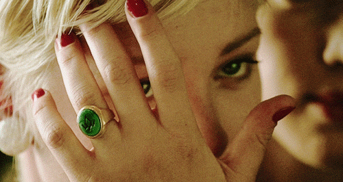 Teresa Banks strokes back her hair while wearing the owl ring