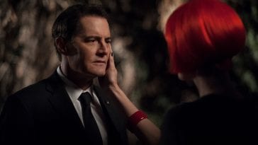 Diane with red hair caresses the face of Dale Cooper