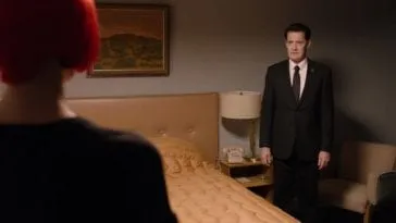 Diane and Cooper acting awkwardly in a motel room