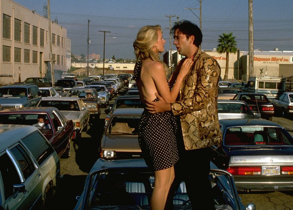 Laura Dern and Nic Cage on top of a car in Wild at Heart 