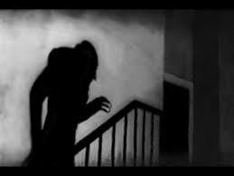 Nosferatu's silhouette as he climbs the stairs