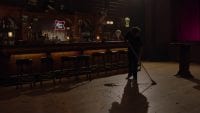 a man sweeps the roadhouse floor