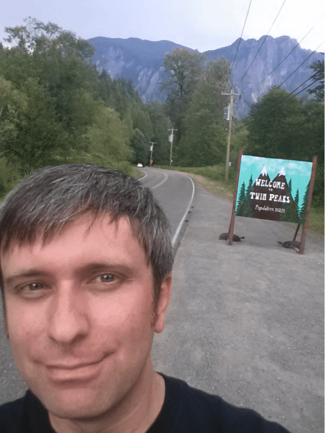 Ben at the Twin Peaks sign in North Bend