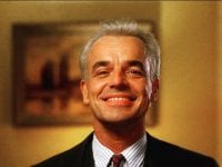 Leland Palmer grins at himself in a mirror
