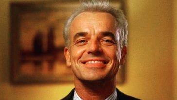Leland Palmer grins at himself in a mirror
