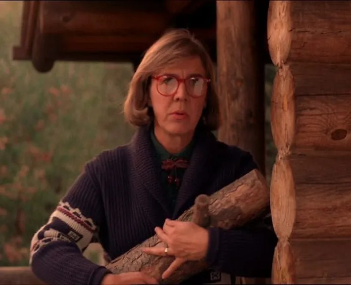 the log lady outside her cabin in the woods