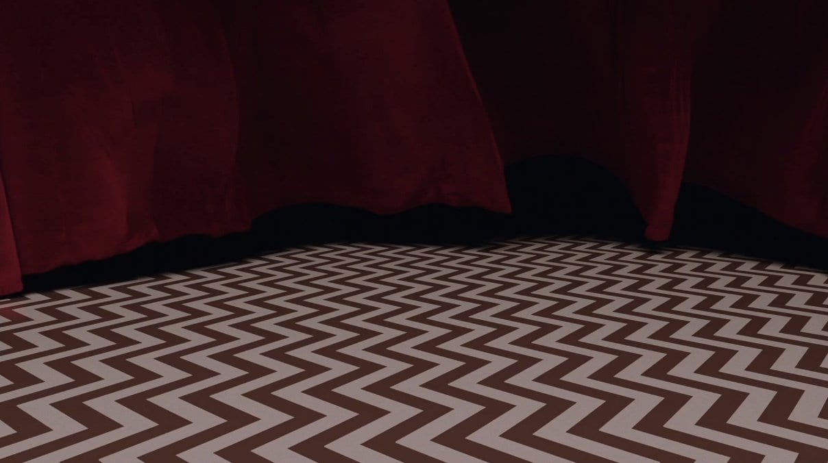 The black lodge with chevron floor and red curtains
