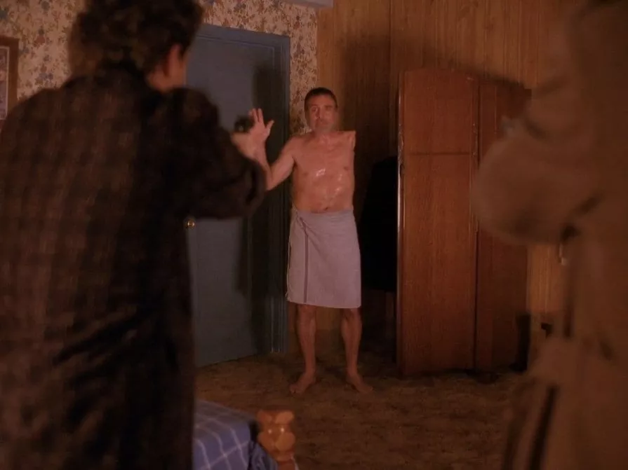 The one armed man raises his hand as Harry storms his room at Timber Falls Motel Twin Peaks