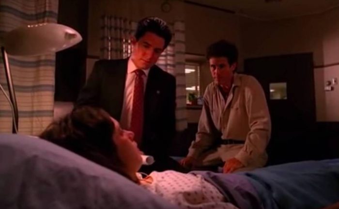 Cooper adjusts his stool at the bedside of Ronette