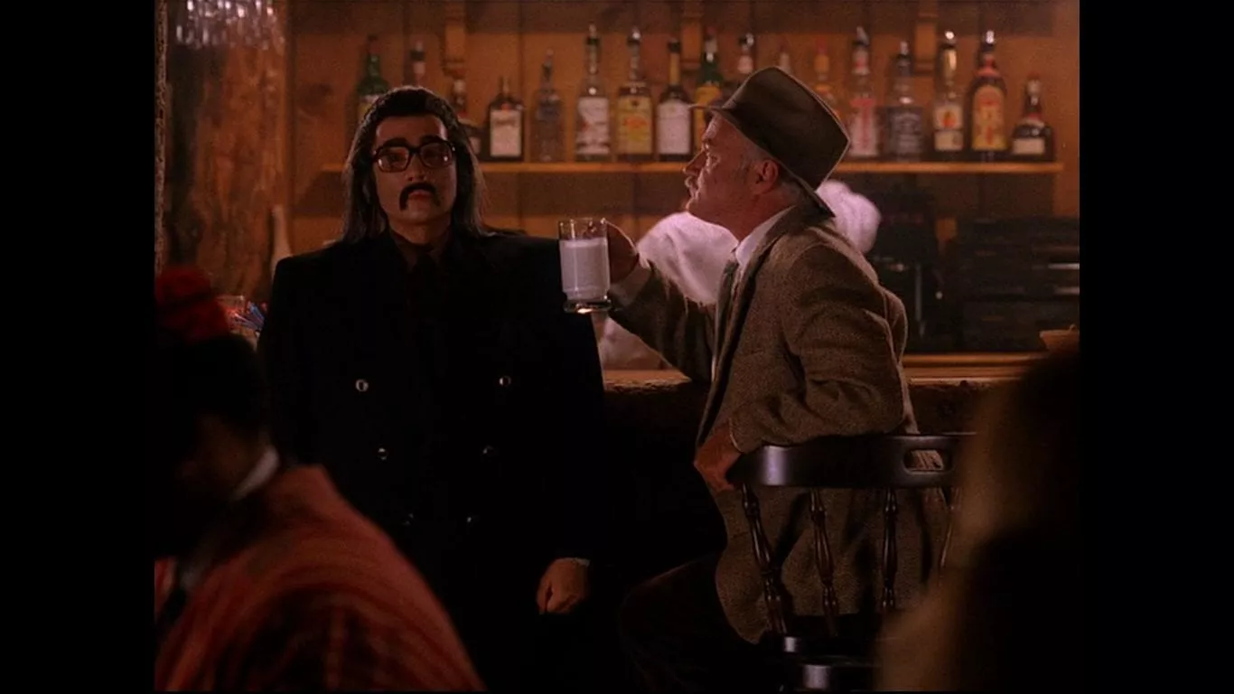 Catherine Martell pretends to be Mr Tojamura, sits at a bar with Pete Martell