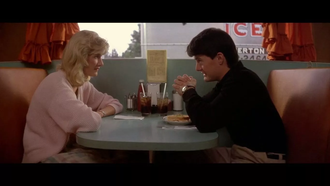 Kyle MacLachlan as Jeffrey in Blue Velvet sitting in a diner opposite Sandy played by Laura Dern