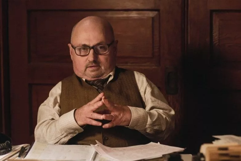 Charlie sits in his office