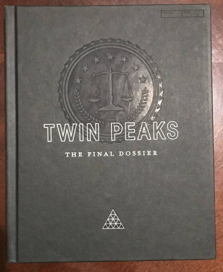 The front cover of the Final Dossier has the official FBI symbol in the center, scales of justice and all. Embossed over it is the title of the book. Near the bottom are triangles that form a larger triangle.
