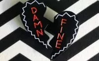 A broken heart which reads Damn Fine on a chevron background