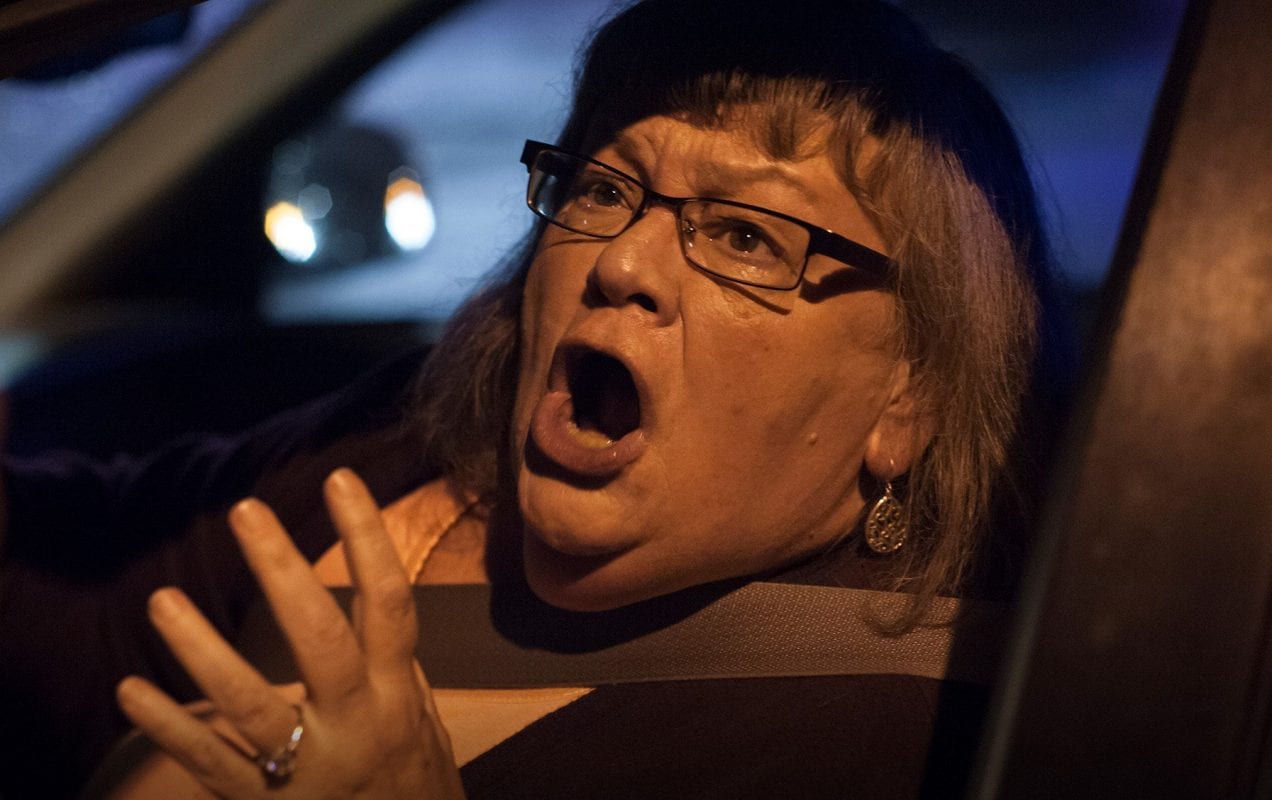a woman screaming from inside her car