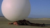 The Prisoner is run over by a giant white ball on the beach