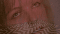 Laura Palmers face superimposed over an image of the Black Lodge