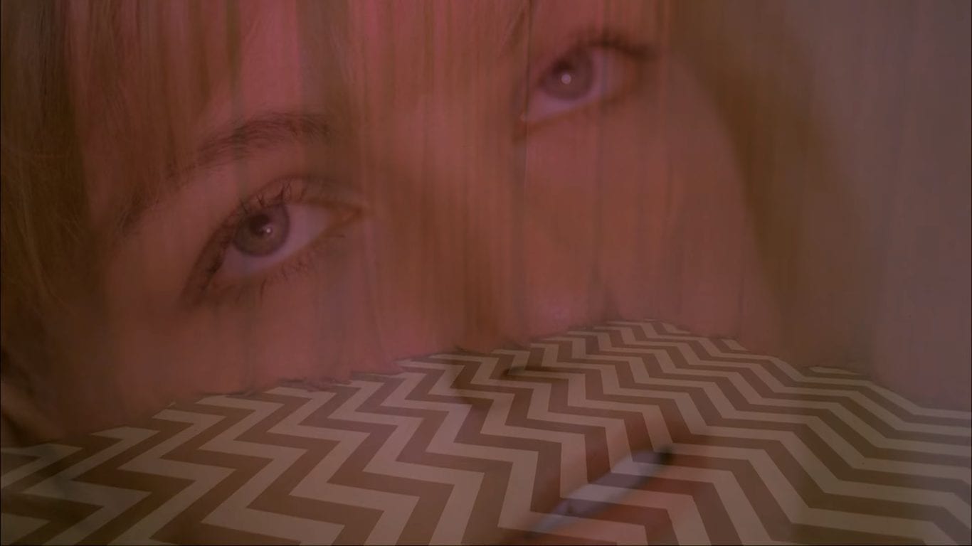 Laura Palmers face superimposed over an image of the Black Lodge