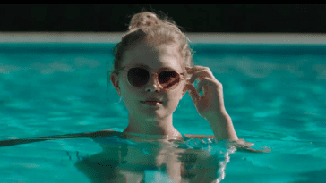 Amma in a swimming pool wearing shades in Sharp Objects
