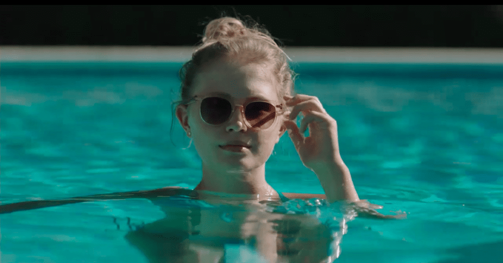 amma in a swimming pool wearing shades in Sharp Objects