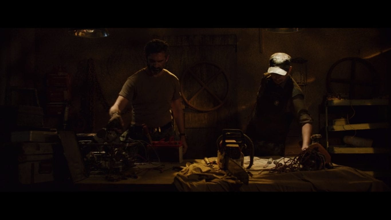2 men prepare chainsaws for battle in Ghoul