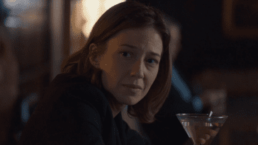 Nora Durst looks down the bar with a martini in front of her