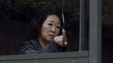 Eve Polastri (Sandra Oh) from Killing Eve contemplates a crack in a bus shelter before smashing the glass