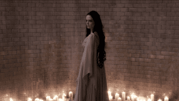 Vanessa (Eva Green) stands in an illuminated chamber as Ethan (Josh Harnett) approaches in the Penny Dreadful season 3 finale