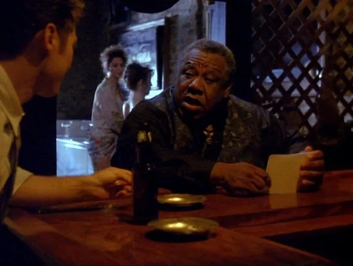 Chino Williams as Fats sitting at the bar