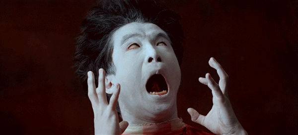 Japanese Butoh dancer expressing trauma through mime with a white painted face