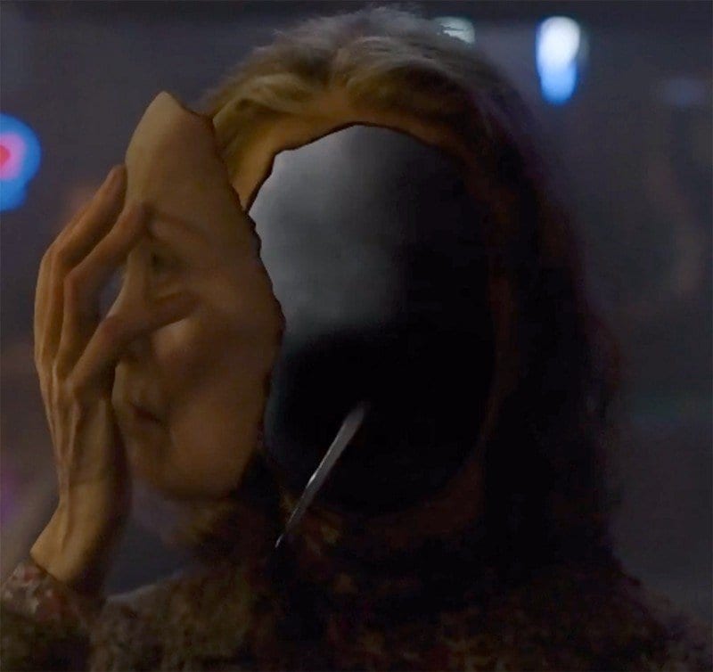 the entity behind Sarah Palmers face has a long sharp tongue or beak
