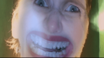 Nikki Graces face warps into a clown smile