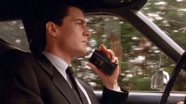Agent Cooper speaking into his recorder, entering Twin Peaks