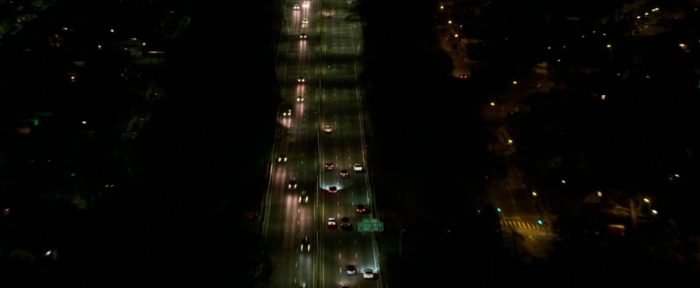 The Safdies pull back the camera, showing a birds-eye view of a freeway in New York City as Connie continues his night-long odyssey.