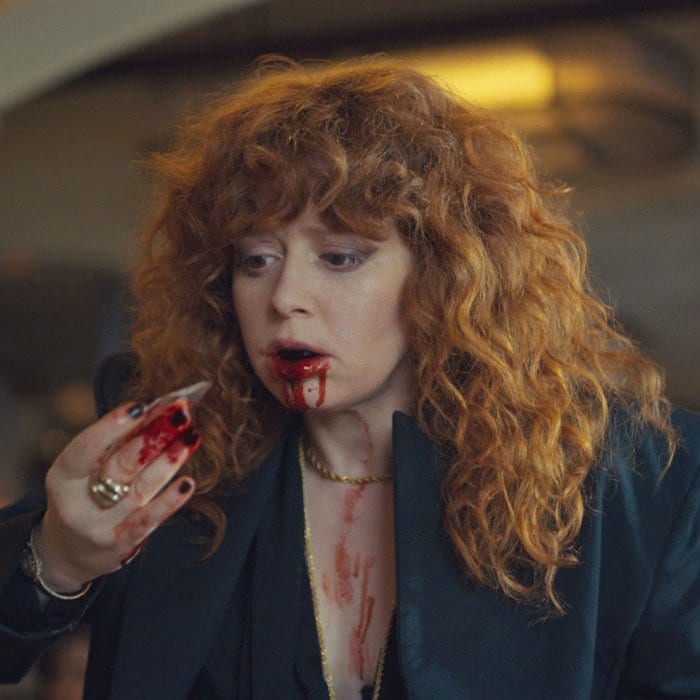 Nadia pulls glass shards from her bloody mouth in Russian Doll.